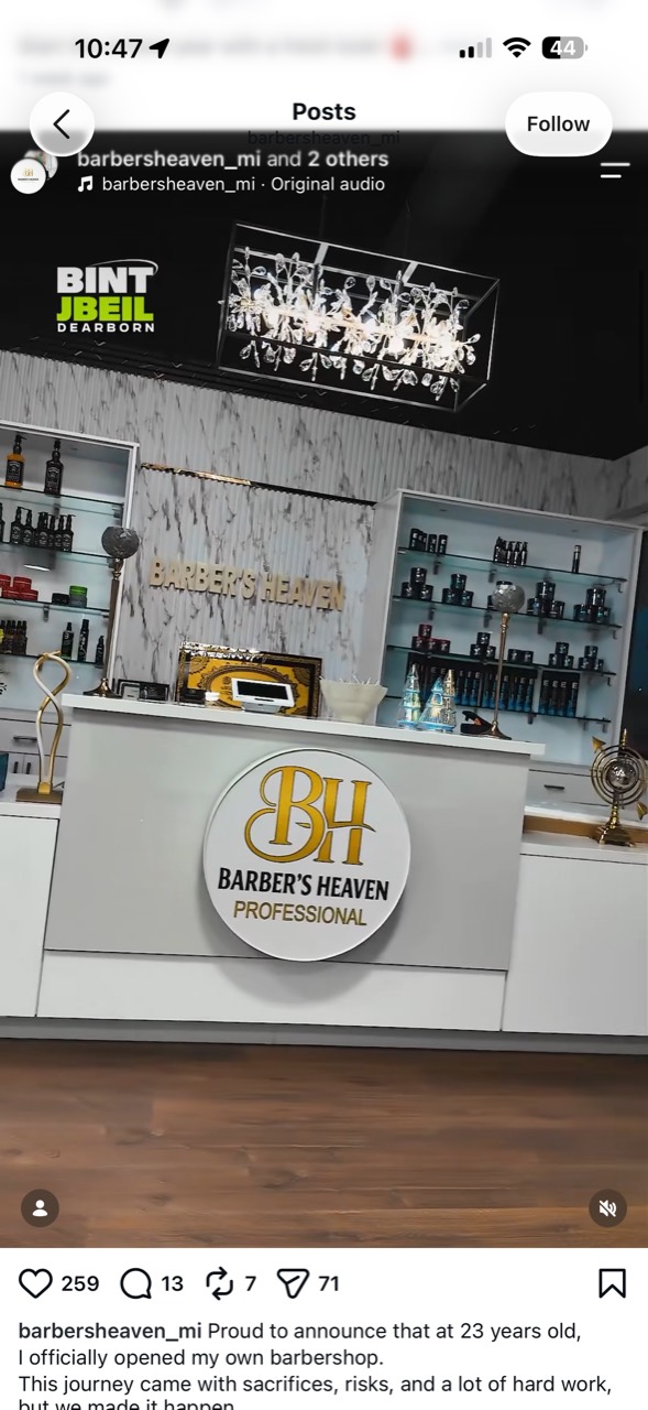 The bright marble and gold front desk at Barber’s Heaven
